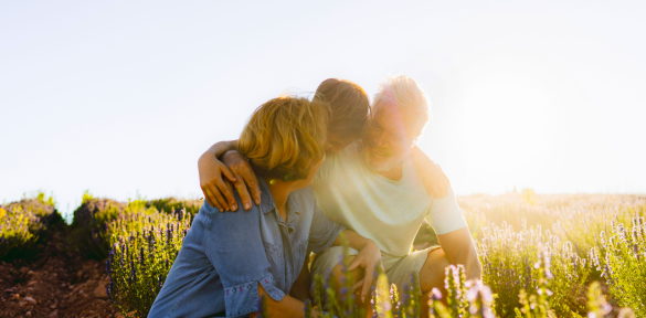 A multigenerational family in a field.