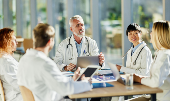 A group of medical professionals around a table.