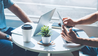 Two people working at a small table.