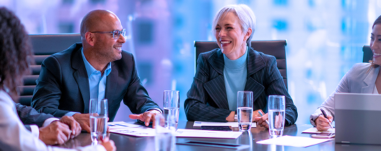 A group of people in a boardroom.