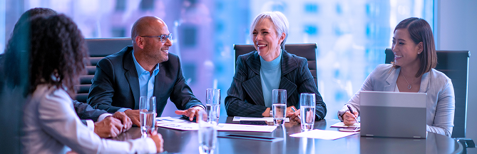 A group of people in a boardroom.