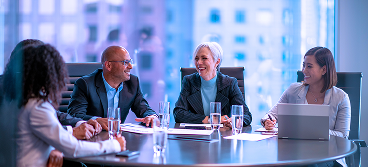 A group of people in a boardroom.