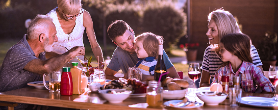 A multigenerational family eating a meal.