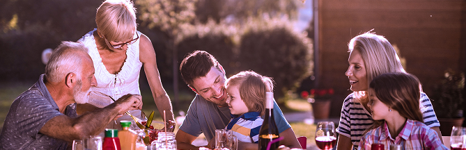 A multigenerational family eating a meal.