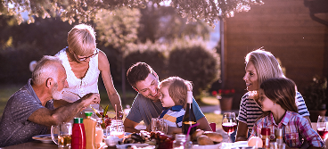 A multigenerational family eating a meal.