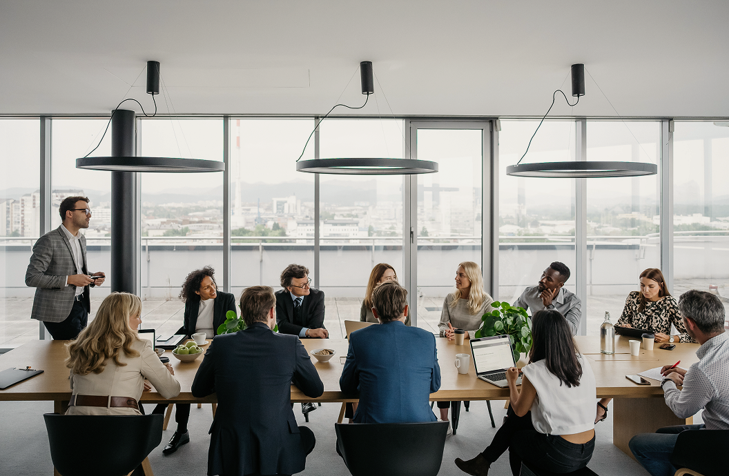 A group of financial professionals working around a board room table.