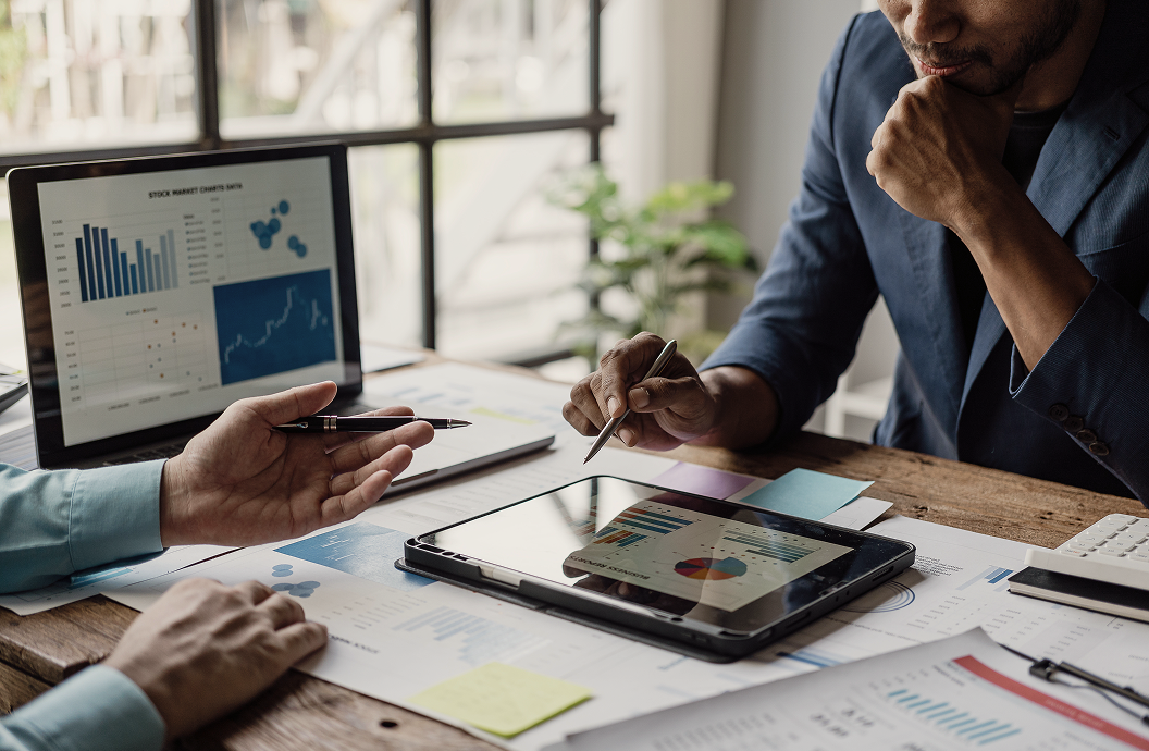 A close up of professionals reviewing a portfolio.