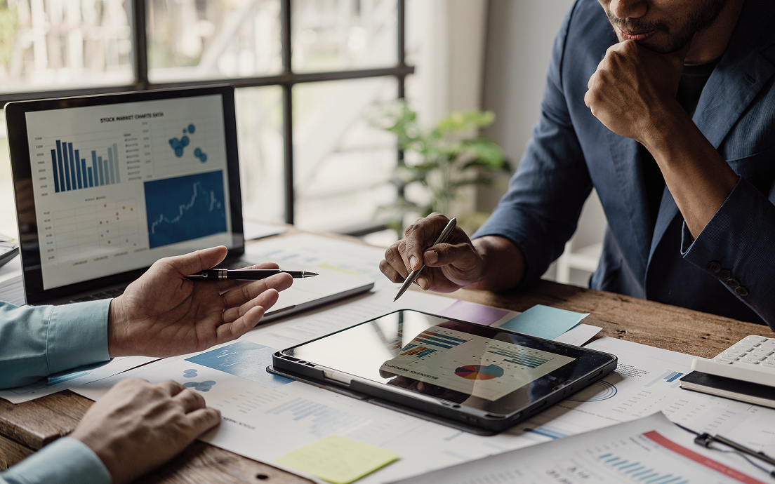 A close up of professionals reviewing a portfolio.