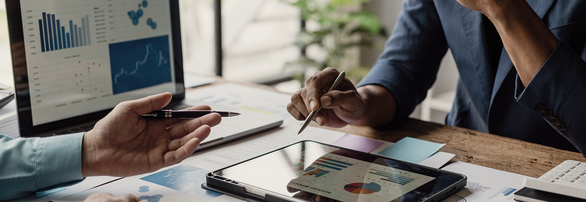 A close up of professionals reviewing a portfolio.