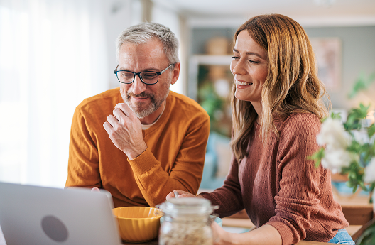 A couple reviewing their financial plan on their laptop.