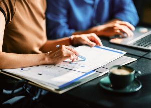 A person examining charts on a table.