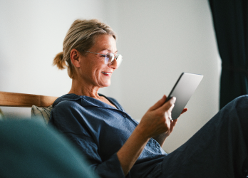 A woman reading on a tablet.