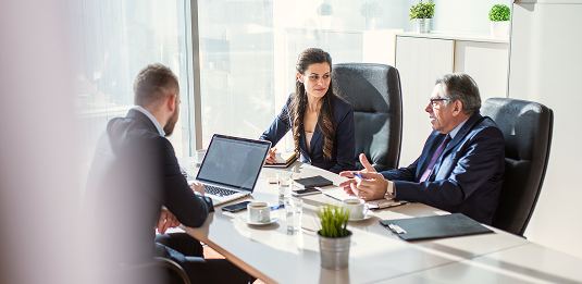 Three people meeting in an office.