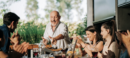 A multigenerational family eating dinner.