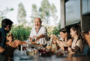 A multigenerational family eating dinner.