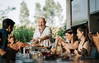 A multigenerational family eating dinner.