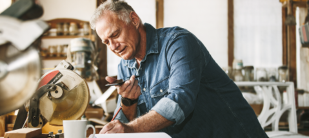 A person on the phone in a workshop.