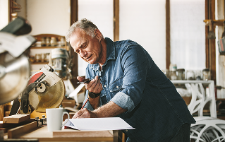 A person on the phone in a workshop.