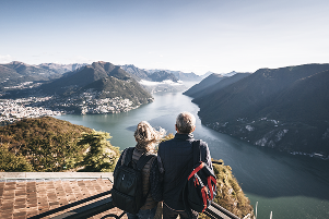 A couple looking out at a mountain valley.