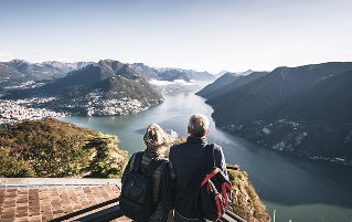 A couple looking out at a mountain valley.