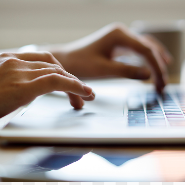 A close-up of an individual typing on their laptop.