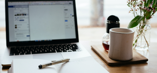A laptop and a mug sitting on a desk